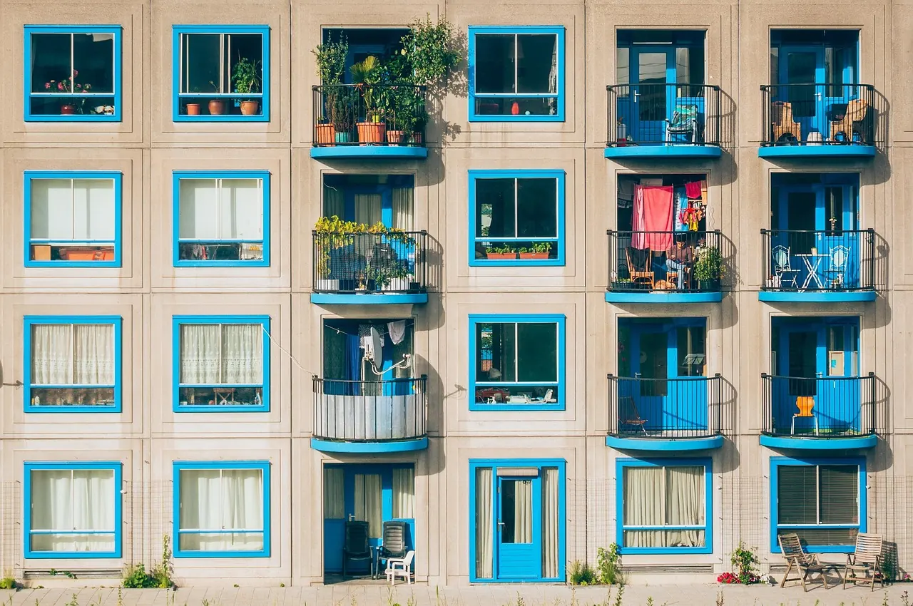 Apartment block with balconies and blue window frames