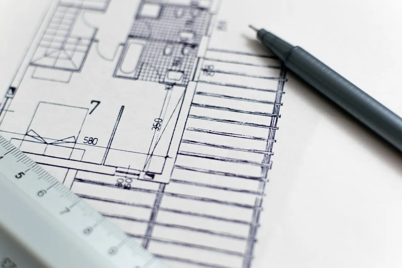 Architectural floor plan drawing with pen and scale ruler