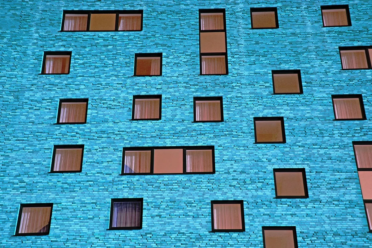 Blue painted building facade with a window pattern