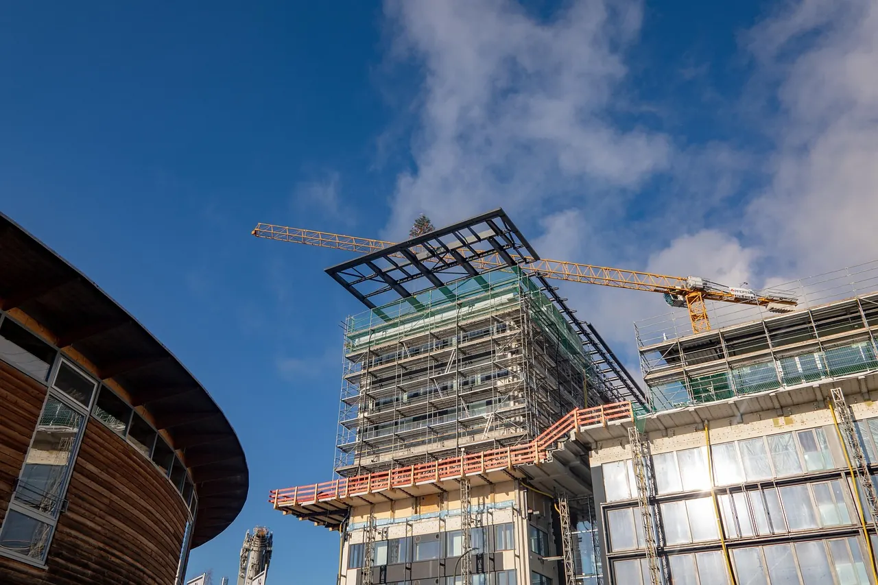 Commercial building under construction with a tower crane