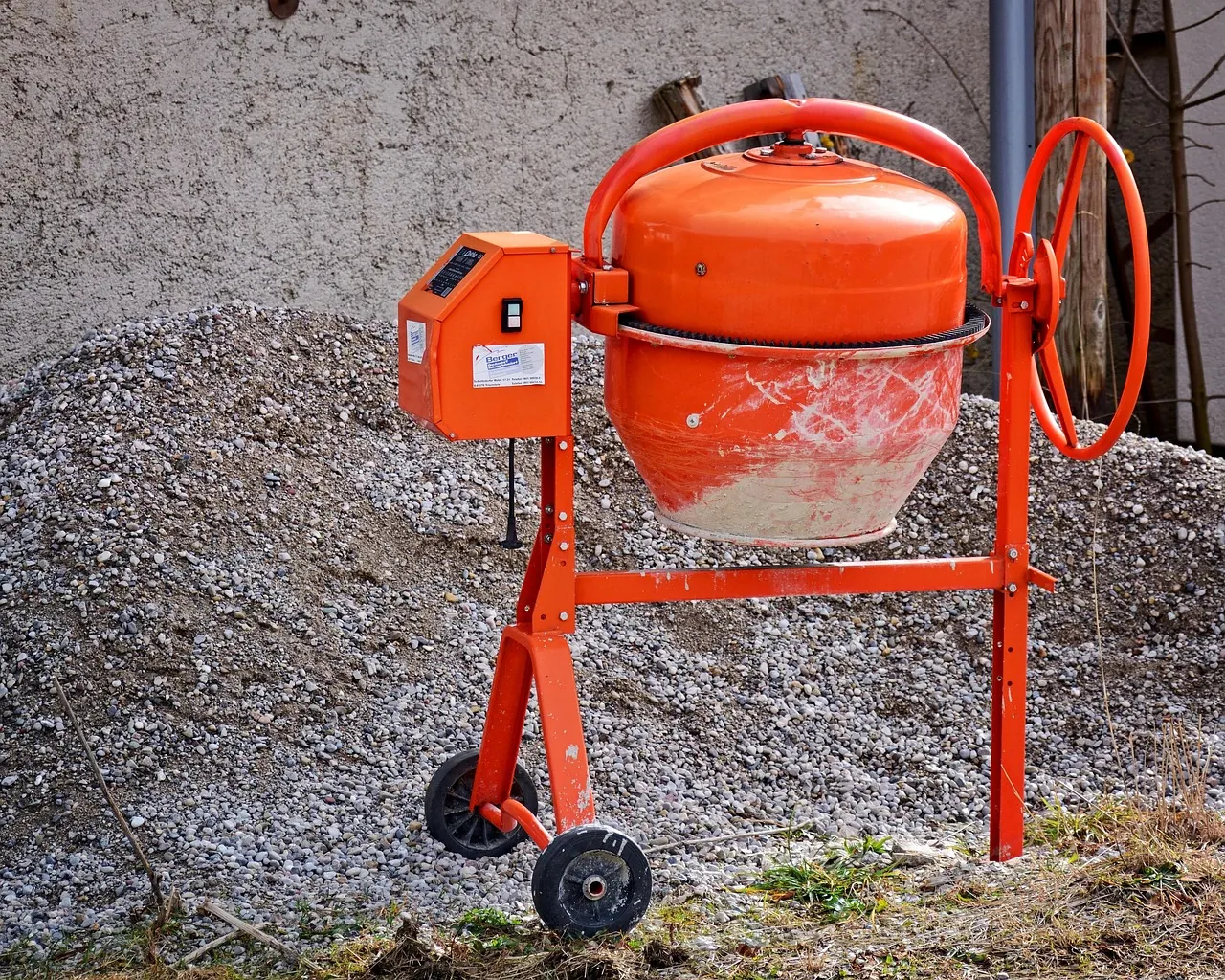 Concrete mixer on a building site beside aggregate