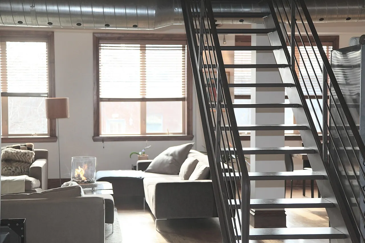 Loft apartment interior with steel staircase and living area