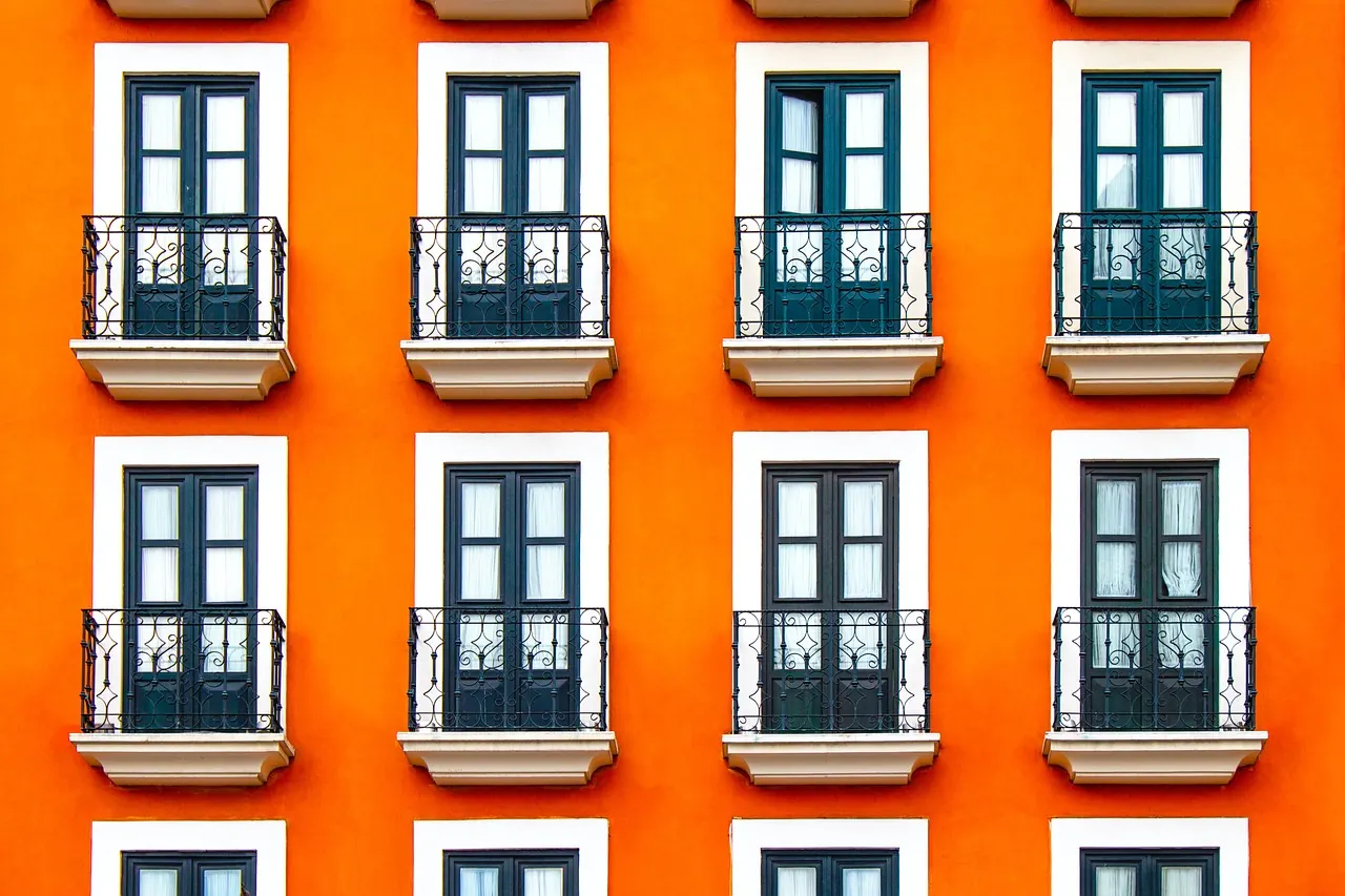 Orange building facade with French balcony windows