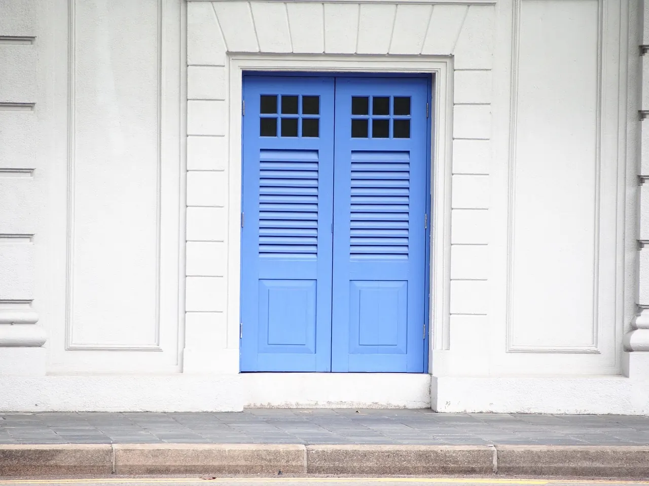 Painted timber double door with louvred panels