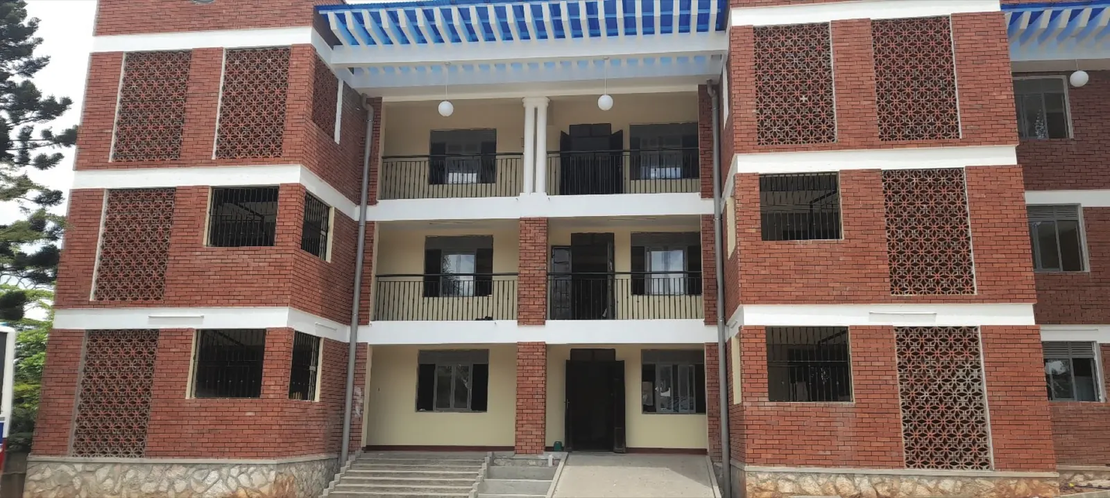 Completed three-storey brick residential apartment block in Uganda