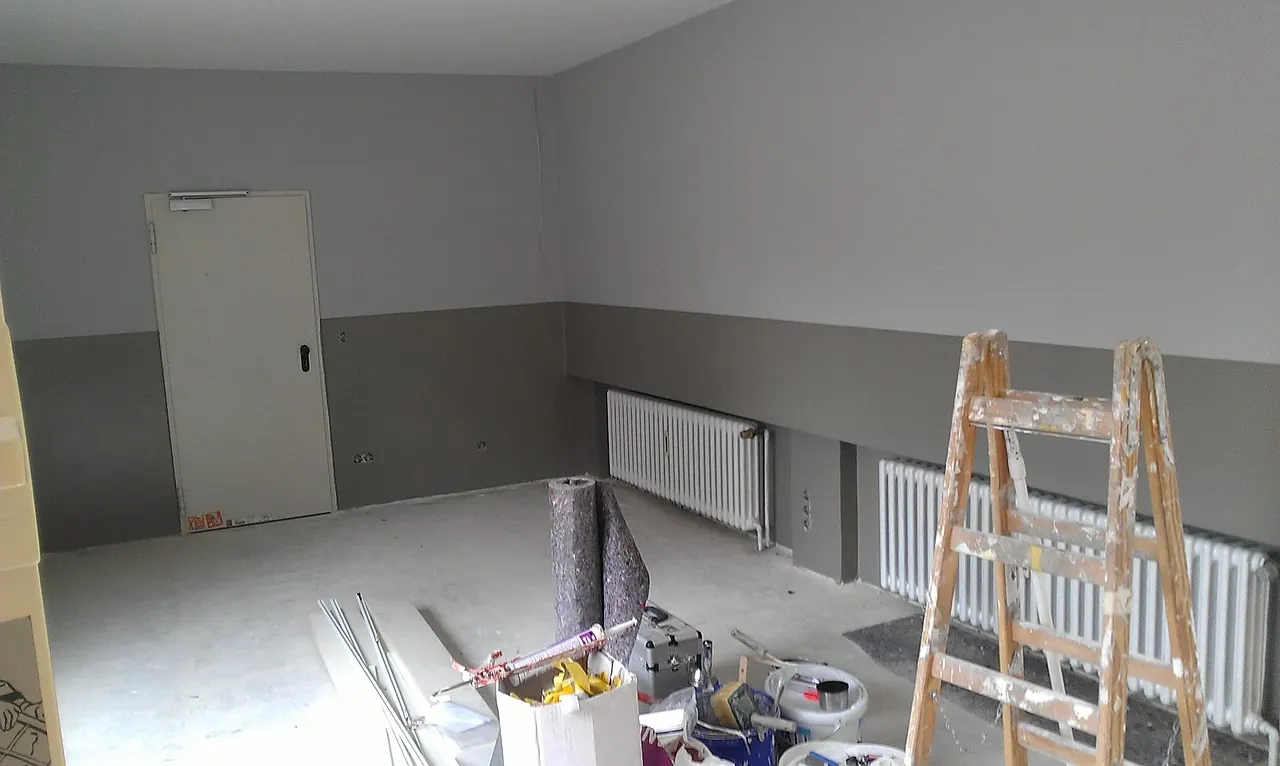 Room renovation in progress with ladder and materials
