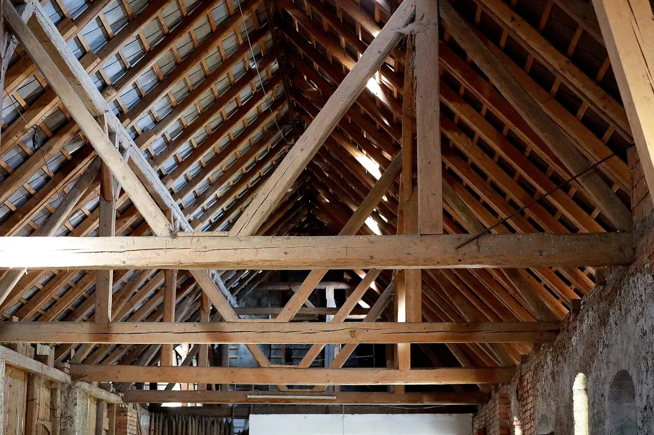 Timber roof trusses and beams in a roof structure