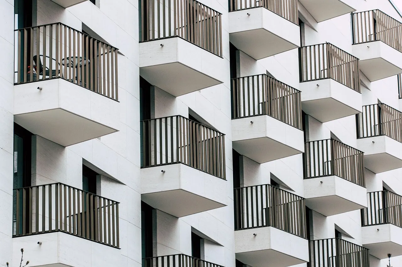 White apartment building with black steel balconies